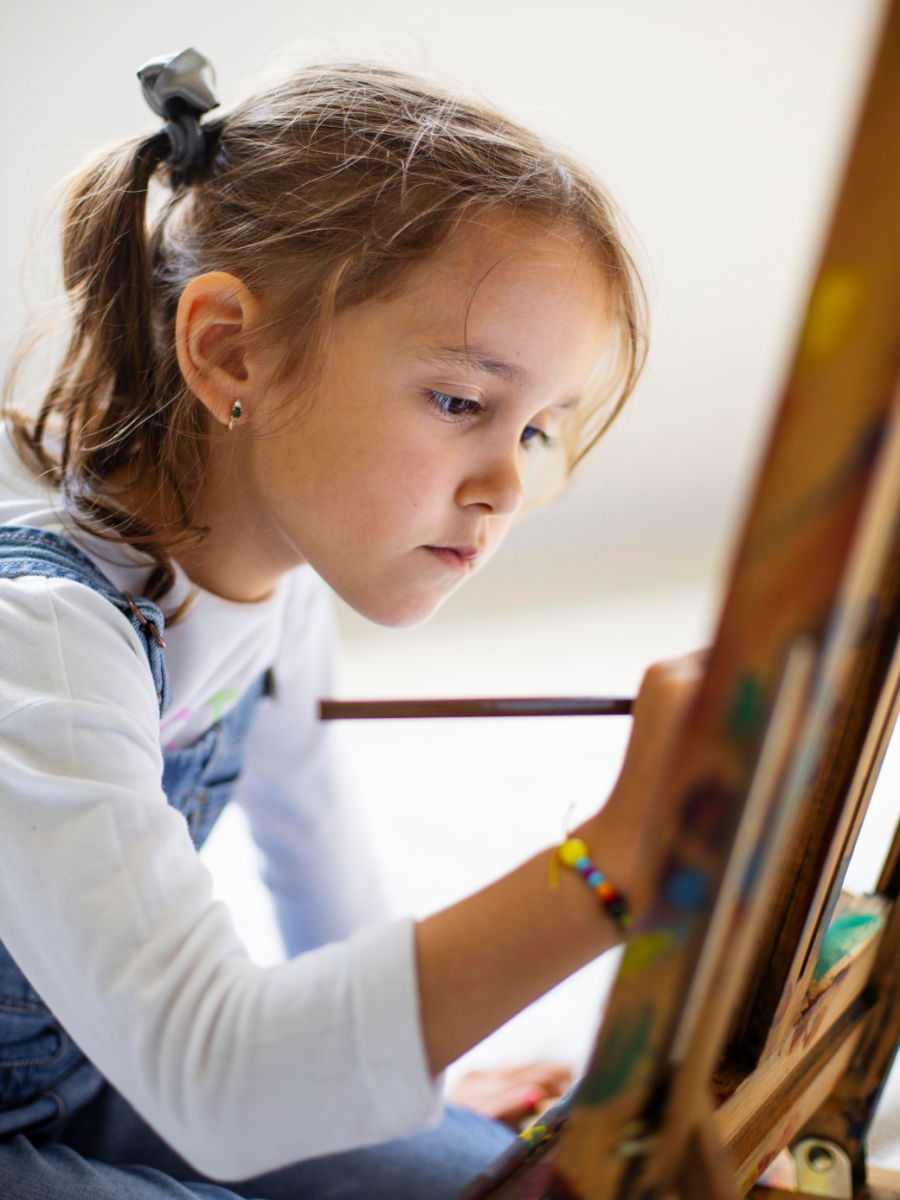 Little girl painting at a party Little girl painting at a party