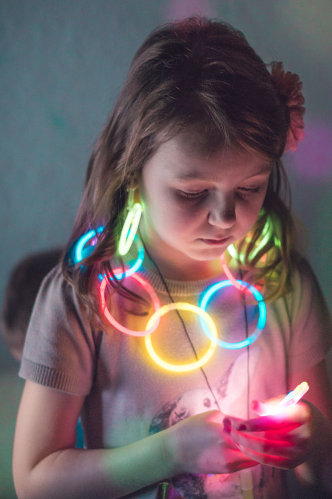 Child wearing glow stick necklace
