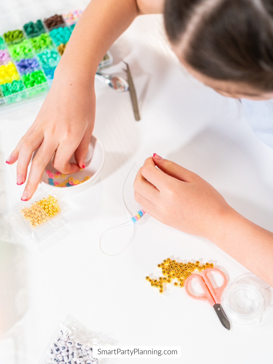Jewelry making A little girl making jewelry at a party